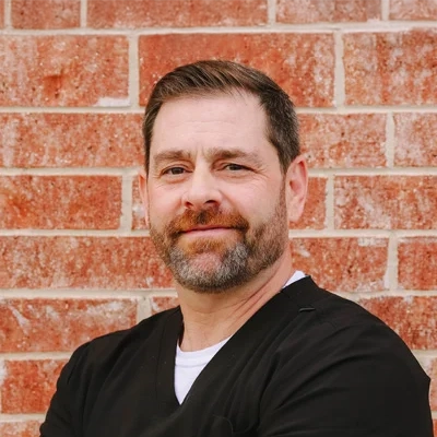Dr. Michael Wojnicki in front of a brick wall.